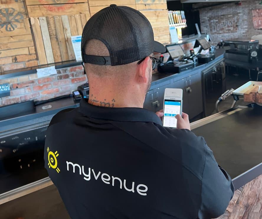 MyVenue staff member with Castles Technology handheld device